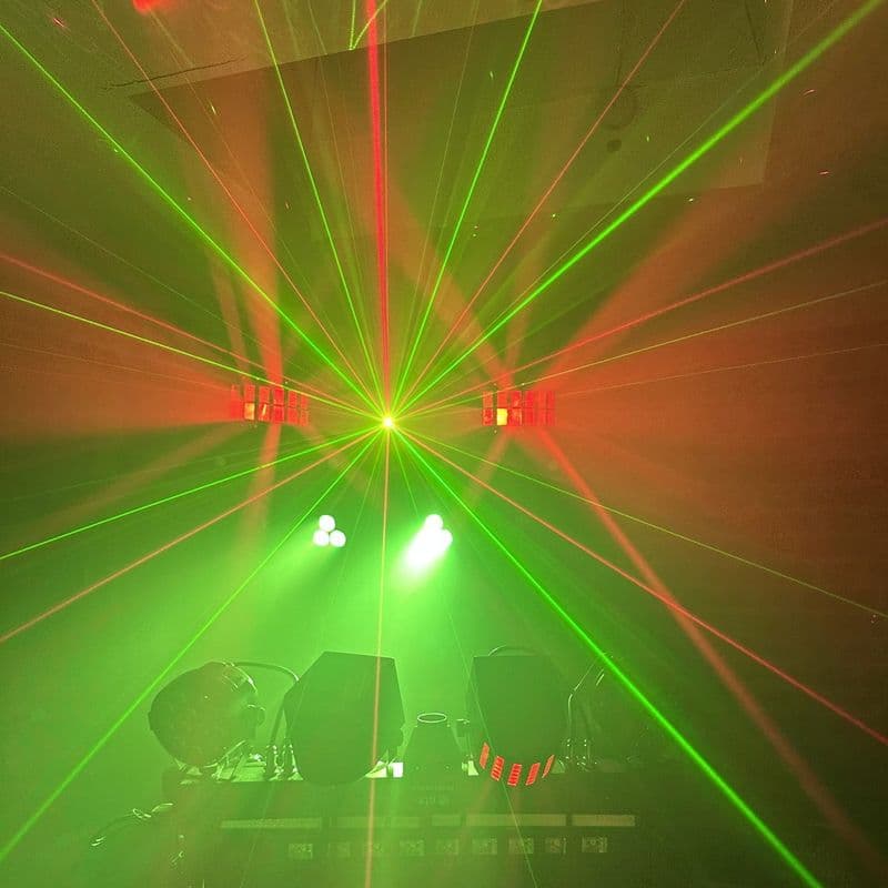 Green and red lasers over the DJ stand, with the moving heads and par cans lit