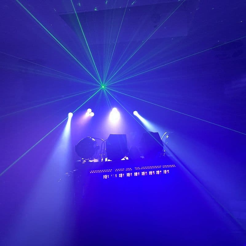 The full lightshow in blue: a laser fan, moving heads and neon under the DJ stand