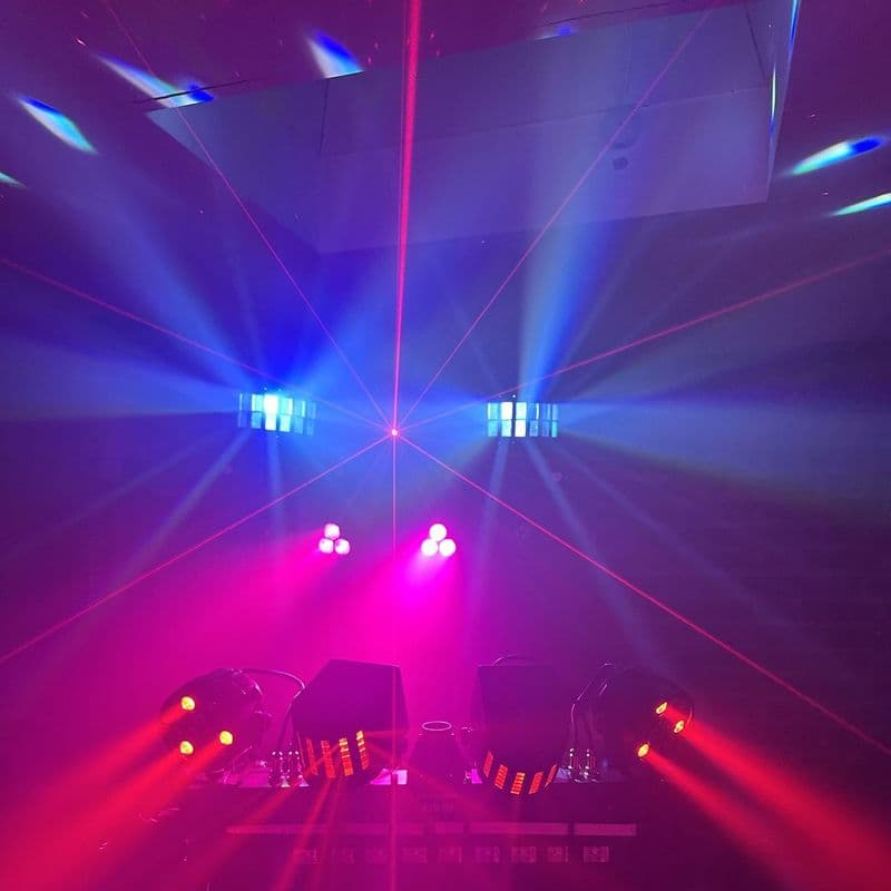Pink and blue beams with lasers and derby effects over the DJ stand
