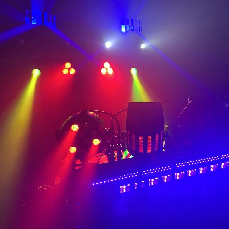 Red and yellow beams from the moving heads and par cans, the neon lit below