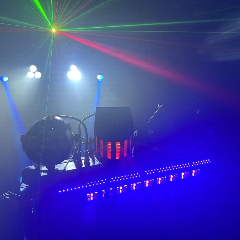A laser fan and white beams over the DJ stand, with the neon underneath