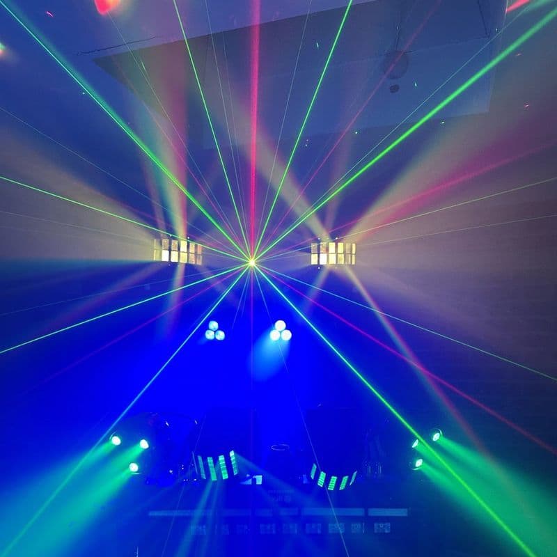 Green lasers and blue beams filling a dark room from the DJ stand